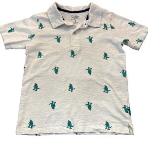 Boys white short sleeved polo shirt with skateboarding dinosaurs; size6; OshKosh